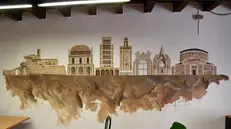 Le pareti decorate della sala civica di via Borgondio