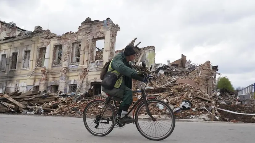 Un uomo in bici passa davanti a un edificio distrutto di Kharkiv, nell'est dell'Ucraina - Foto Epa © www.giornaledibrescia.it