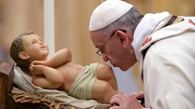 Papa Francesco bacia la statuetta di Gesù Bambino -  Foto ANSA/ETTORE FERRARI