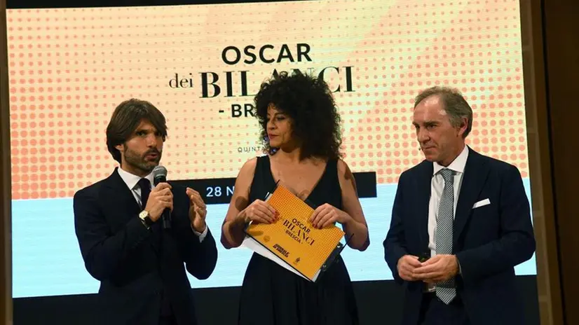 I giornalisti Bissolotti e Bariselli con il prof. Teodori sul palco di una precedente edizione dell'Oscar dei Bilanci - Foto New Reporter  © www.giornaledibrescia.it