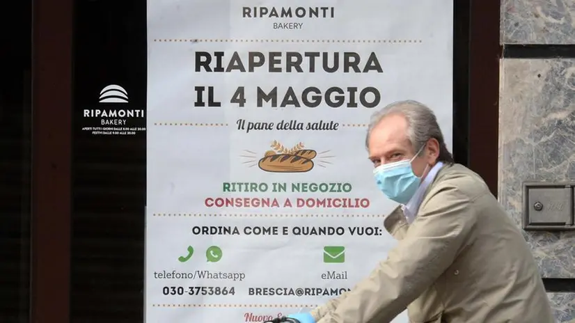 Un manifesto sulla vetrina di un negozio - © www.giornaledibrescia.it