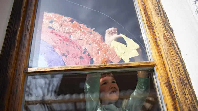Un bambino in casa colora i vetri delle finestre - Foto © www.giornaledibrescia.it