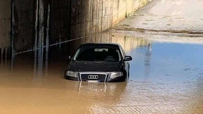 Un’auto bloccata nella «piscina» di acqua piovana del sottopasso - © www.giornaledibrescia.it