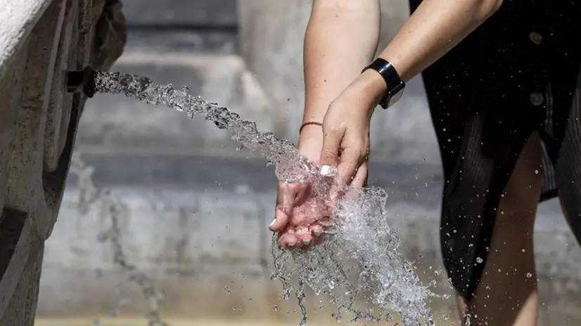 Una ragazza si rinfresca ad una fontana (archivio) - Foto Ansa © www.giornaledibrescia.it