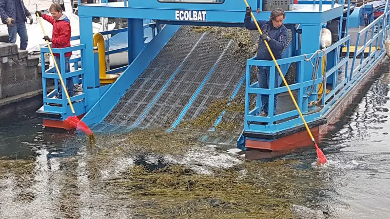 Battello spazzino al lavoro a Iseo