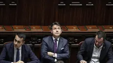 Il premier Giuseppe Conte con Luigi Di Maio e Matteo Salvini - Foto Ansa/Giuseppe Lami