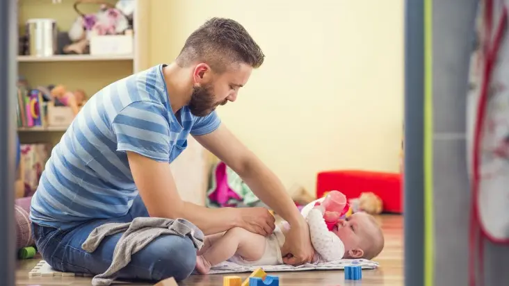 Il papà alle prese col cambio del pannolino © www.giornaledibrescia.it