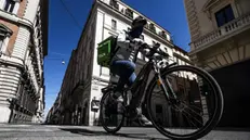 Un rider in bicicletta - Foto Ansa © www.giornaledibrescia.it