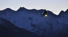 Elisoccorso notturno. Elicottero del Soccorso alpino valdostano all'aeroporto Corrado Gex di Saint-Christophe (Aosta)
