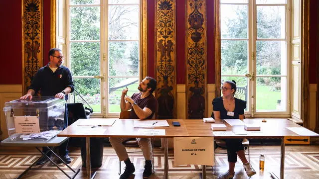 epa11125902 Employees work at a polling station during a referendum on higher parking fees for SUVs in Paris, France, 04 February 2024. Parisians are called to vote in a referendum on 04 February 2024, for a proposal by Paris municipal to triple the parking rates for tall and heavy cars called SUV (sport utility vehicle).  EPA/MOHAMMED BADRA