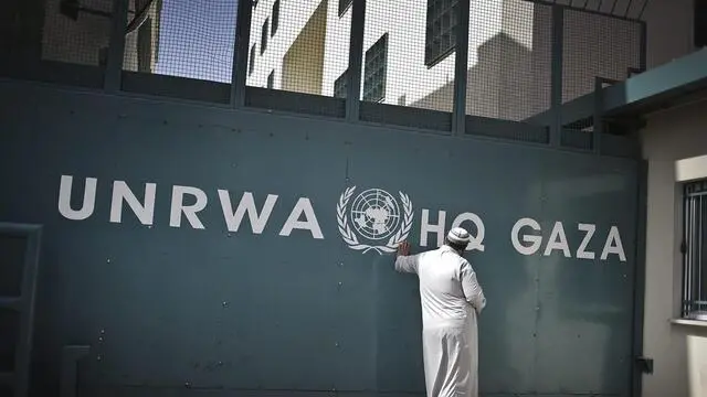 epa03652023 A Palestinian man leans against the closed gate of the United Nations Relief and Works Agency (UNRWA) headquarter in Gaza Strip, 06 April 2013. The UN aid agency said on 04 April that it has suspended operations in the Gaza Strip after angry Palestinians stormed one its compounds in the impoverished enclave to protest cuts. The UNRWA said in a statement it had to reduce cash payments to the poorest refugee families in the Gaza Strip as a result of budget shortfalls. 'The situation could very easily have resulted in serious injuries to UNRWA staff and to the demonstrators', Robert Turner, UNRWA head in Gaza, said after the incident on 04 April. 'This escalation, apparently pre-planned, was unwarranted and unprecedented'.  EPA/ALI ALI