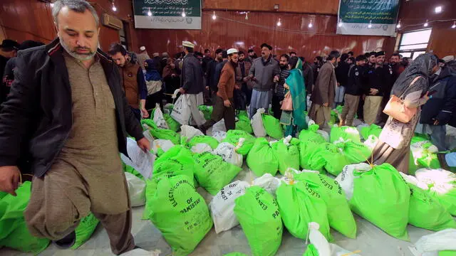 epa11133694 Pakistan polling staff carry election materials at a distribution center on the eve of the general election, in Peshawar, the provincial capital of Khyber-Pakhtunkhwa province, Pakistan, 07 February 2024. The Election Commission of Pakistan (ECP) has announced that general elections for the parliament and four provincial assemblies are scheduled to take place on 08 February 2024. The National Assembly comprises 266 general and 70 reserved seats.  EPA/ARSHAD ARBAB