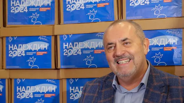 epa11115340 Boris Nadezhdin, Russian presidential candidate from the Civil Initiative party and deputy of the Council of Deputies of the Dolgoprudny urban district of the Moscow Region, stands in front boxes reading 'Nadezhdin 2024' as he arrives for a procedure to submit citizens’ signatures for his nomination as presidential candidate to the Central Election Commission in Moscow, Russia, 31 January 2024.  On December 07, the Federation Council adopted a resolution calling elections for the President of the Russian Federation. The Central Election Commission decided to hold presidential elections within three days - from 15 to 17 March 2024.  EPA/MAXIM SHIPENKOV