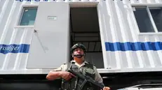 epa11138307 A member of police stands next to a mobile barrack donated by the US government to the Ecuadorian Police, in Quito, Ecuador, 08 February 2024. The United States Government announced the donation to the National Police of Ecuador of 'sophisticated' mobile barracks to monitor the border with Colombia, as part of a process of cooperation in security and combating crime.  EPA/Jose Jacome