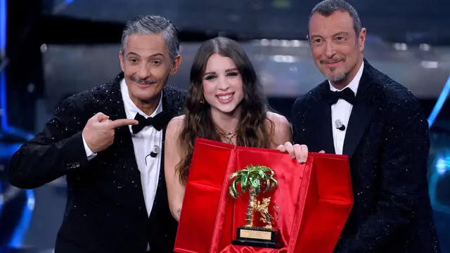 Angelina Mango (C) with the trophy after winning the Sanremo Italian Song Festival with Sanremo Festival host and artistic director Amadeus (R) and Sanremo Festival co-host and Italian showman Rosario Fiorello (L) on stage at the Ariston theatre during the 74th Sanremo Italian Song Festival, Sanremo, Italy, 10 February 2024. The music festival will run from 06 to 10 February 2024. ANSA/ETTORE FERRARI