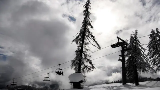 epa08996259 Lara Gut of Switzerland sits on a chairlift during the Alpine Skiing World Championships in Cortina d'Ampezzo, Italy, 08 February 2021. Due to heavy snowfall the Women's Alpine Combined event was cancelled earlier this day.  EPA/CHRISTIAN BRUNA