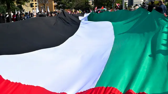 epa11144771 People march with a Palestinian flag during a protest in solidarity with Gaza and the Palestinian people on the occasion of 'International Jerusalem Week', organized by associations and civil society bodies in Lebanon, outside the United Nations Economic and Social Commission for Western Asia (UN-ESCWA) headquarters in Beirut, Lebanon, 11 February 2024. Thousands of Israelis and Palestinians have been killed since the militant group Hamas launched an unprecedented attack on Israel from the Gaza Strip on 07 October 2023, and the Israeli strikes on the Palestinian enclave which followed it. EPA/WAEL HAMZEH
