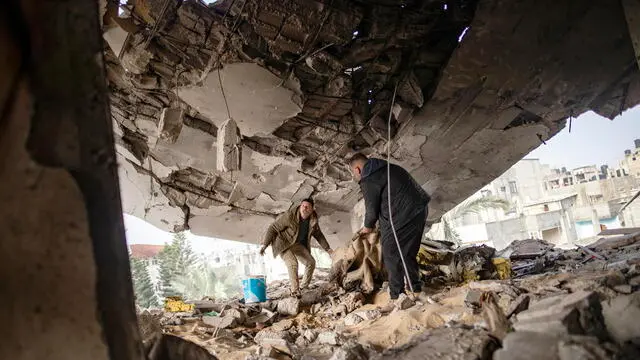 epa11141419 Palestinians from the Ghannam family check the damages inside the family home after an Israeli air strike hit the Rafah refugee camp, southern Gaza Strip, 10 February 2024. Israel's Prime Minister Netanyahu on 09 February ordered the Israeli military to present a plan of evacuation of Palestinians from Rafah. Nearly 28,000 Palestinians and over 1,300 Israelis have been killed, according to the Palestinian Health Ministry and the Israel Defense Forces (IDF), since Hamas militants launched an attack against Israel from the Gaza Strip on 07 October 2023, and the Israeli operations in Gaza and the West Bank which followed it.  EPA/HAITHAM IMAD