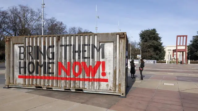 epa11131843 The words 'Bring them home now!' are painted on a container, which is part of an installation aimed at replicating the conditions under which Israeli hostages are held by Hamas in underground tunnels in the Gaza Strip, displayed on the place des Nations in front of the European headquarters of the United Nations in Geneva, Switzerland, 06 February 2024. The event was organized by a Geneva citizens' group with the association of relatives of hostages in Israel. According to the Israeli military, 136 Israelis, who were abducted and taken to the Gaza Strip during the 07 October 2023 attacks by Hamas, remain in captivity. EPA/SALVATORE DI NOLFI