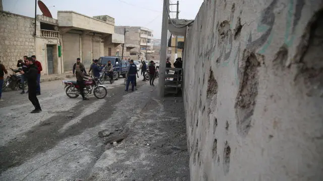 epa11052486 People inspect a damaged area after shells fell on a residential area, in Daret Azzah city, Aleppo countryside, Syria, 01 January 2024. According to the White Helmets, the Syrian civil group in north-west Syria, at least six people were killed and a dozen injured after artillery and missile shelling fired from government-controlled areas targeted residential neighborhoods in the rebel-held Aleppo countryside. The UK-based Syrian Observatory for Human Rights (SOHR) said an exchange of attacks erupted on 01 January between government-controlled areas and rebel factions in Aleppo countryside.  EPA/BILAL AL-HAMMOUD