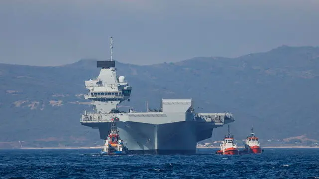 epa09328199 A handout picture provided by the UK Ministry of Defence shows the HMS Prince of Wales arriving in Gibraltar, 06 July 2021 (issued 07 July 2021). The Royal Navy aircraft carrier has made its first overseas port visit in Gibraltar. EPA/Mark Johnson/BRITISH MINISTRY OF DEFENCE/HANDOUT MANDATORY CREDIT: MOD/CROWN COPYRIGHT HANDOUT EDITORIAL USE ONLY/NO SALES
