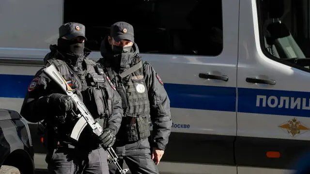epa10912744 Armed Russian police officers keep watch during a court hearing of the case of human rights activist and chairman of the Human Rights Center 'Memorial', Oleg Orlov at the Golovinsky District Court in Moscow, Russia, 11 October 2023. In June 2023, the court started considering the criminal case against Oleg Orlov, who is accused of 'repeatedly discrediting' the Russian army and risks up to three years in a penal colony. EPA/YURI KOCHETKOV