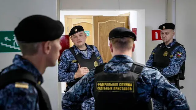 epa10581502 Russian policemen stand guard in the Yefremov Interdistrict Court before a court hearing in Yefremov town, Tula region, Russia, 20 April 2023. The Yefremov Interdistrict Court held a closed session with the participation of Masha Moskaleva and her mother Olga Sitchikhina to consider the issue of limiting both parental rights. In the spring of last year, Masha Moskaleva, the then 12-year- old, drew an anti-war drawing in an art lesson. Her father Alexei Moskalyov was fined under an article on discrediting the army, and later detained and placed under house arrest. He fled before the court session at which the verdict was announced and later the Ministry of Internal Affairs of Belarus reported his detention in Minsk. Masha had been placed at a children's home. EPA/YURI KOCHETKOV