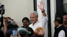 epa11151708 Indonesian Presidential candidate Ganjar Pranowo (C) waves to jornalists next to his running mate, Mahfud MD (R), during their meeting in Jakarta, Indonesia, 14 February 2024. More than 200 million voters in Indonesia will head to the polls on 14 February 2024 to elect a new president, vice president, parliamentary and local representatives in the worldâ€™s largest single-day election.  EPA/BAGUS INDAHONO