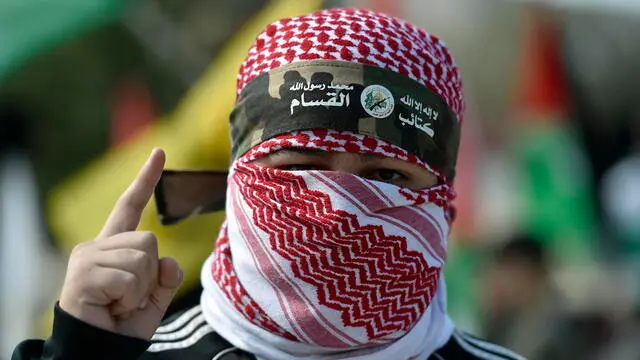 epa11144780 A protester covering his face with a Palestinian traditional keffiyeh and headband that reads in Arabic 'No God but Allah and Muhammed is his messenger, al-Qassam Brigades', the military wing of the Hamas movement, during a protest in solidarity with Gaza and the Palestinian people on the occasion of 'International Jerusalem Week', organized by associations and civil society bodies in Lebanon, outside the United Nations Economic and Social Commission for Western Asia (UN-ESCWA) headquarters in Beirut, Lebanon, 11 February 2024. Thousands of Israelis and Palestinians have been killed since the militant group Hamas launched an unprecedented attack on Israel from the Gaza Strip on 07 October 2023, and the Israeli strikes on the Palestinian enclave which followed it. EPA/WAEL HAMZEH