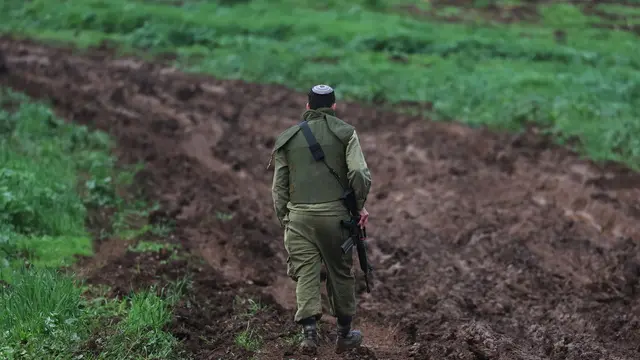 epa11085566 An Israeli soldier of an artillery unit located at the Israeli border with Lebanon, as tension continue to rise between the two countries, at an undisclosed location 17 January 2024. The Israeli army reported that an anti-tank missile launch from Lebanon toward the area of Gladiola was identified. In response, fighter jets struck Hezbollah terrorist infrastructure and military compounds in the area of Hula in Lebanon. EPA/ATEF SAFADI