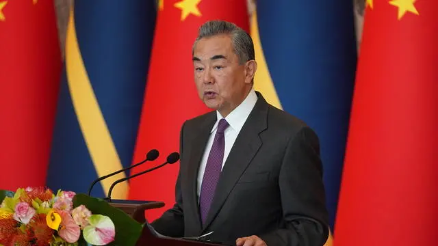 epa11100152 Chinese Foreign Minister Wang Yi gives a speech after signing the Joint Communiqué on the Resumption of Diplomatic Relations between the People's Republic of China and the Republic of Nauru, at Diaoyutai State Guesthouse in Beijing, China, 24 January 2024.  EPA/Andrea Verdelli / POOL