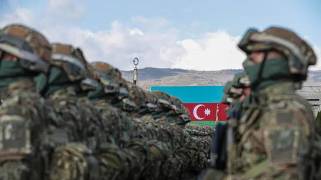 epa10963968 Azeri servicemen attend a military parade marking the third anniversary of the Victory in the Patriotic War, in the former capital of Nagorno-Karabakh region, known to Armenians as Stepanakert, and in Azerbaijan as Khankendi, Azerbaijan, 08 November 2023. Azerbaijan on 19 September 2023 launched a brief military offensive in the contested region of Nagorno-Karabakh, a breakaway enclave home to some 120,000 ethnic Armenians. Following a ceasefire agreed on the following day, Azerbaijan opened all checkpoints with Armenia for the unimpeded exit of civilians from the disputed territory. The Armenian government announced the evacuation of more than 100,000 local residents from Nagorno-Karabakh, and a humanitarian center was set up in the village of Kornidzor near the so-called Lachin corridor, the main route between Armenia and the breakaway region. Nagorno-Karabakh will cease to exist as a self-proclaimed state from 01 January 2024, the region's separatist leader, Samvel Shakhramanyan, announced on 28 September 2023, after signing a decree to dissolve all its institutions.  EPA/STRINGER