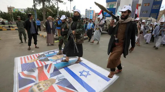 epa11137135 New Houthi recruits step on a banner depicting Israeli Prime Minister Netanyahu, US President Biden and British Prime Minister Sunak during a gathering to show defiance against the US-British strikes on Houthi positions, in Sana'a, Yemen, 08 February 2024. Yemen's Houthis have been mobilizing and recruiting more fighters as part of a mobilization campaign for a possible confrontation with the United States and Israel amid fears of a wider regional conflict stemming from escalating Houthi attacks on shipping lanes in the Red Sea and the Gulf of Aden. The United States Central Command (CENTCOM) said that it had attacked missiles from the Houthis that were ready to be launched against merchant ships in the Red Sea, two days after it identified six anti-ship ballistic missile launched by the Houthis toward the southern Red Sea and the Gulf of Aden. In January 2024, the US Department of State designated Yemen's Houthis as a 'Specially Designated Global Terrorist group' due to their increased attacks on shipping lanes. In December 2023, the US Department of Defense announced a multinational operation to safeguard trade and protect ships in the Red Sea in response to the escalation of Houthi attacks.  EPA/YAHYA ARHAB