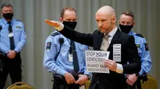 epa09692476 Mass murder Anders Behring Breivik poses with a fascist salute as he arrives for the first day of the parole hearing of Anders Breivik, in Skien, Norway, 18 January 2022. Breivik, who changed his name to Fjotolf Hansen in 2017, is to appear before court for his three-days parole hearing in Oslo on 18 January 2022. Mass murderer Anders Behring Breivik was sentenced to a maximum term of 21 years for killing 77 people in bomb and shooting attacks on 22 July 2011, and is entitled under Norwegian law to have his sentenced reviewed after ten years served. The case is being processed by Telemark District Court, but is physically taking place in a makeshift courtroom in Skien prison.  EPA/Ole Berg-Rusten / POOL NORWAY OUT NORWAY OUT