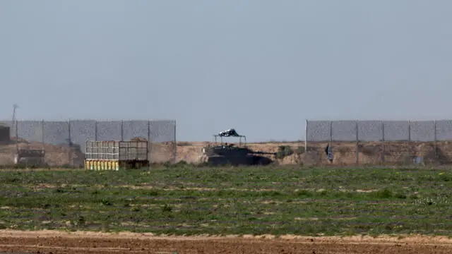 epa11103232 An Israeli armoured fighting vehicle crosses a fence near the border with southern Gaza, at an undisclosed location in southern Israel, 25 January 2024. More than 25,700 Palestinians and at least 1,330 Israelis have been killed, according to the Palestinian Health Ministry and the Israel Defense Forces (IDF), since Hamas militants launched an attack against Israel from the Gaza Strip on 07 October 2023, and the Israeli operations in Gaza and the West Bank which followed it. The Israeli military stated on 25 January that its troops have conducted 'targeted raids on military sites' in the Al Amal area in Khan Yunis, southern Gaza.  EPA/ATEF SAFADI