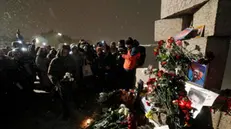 epa11159148 People lay flowers and light candles next to the photo of Russian late opposition leader Alexey Navalny during a vigil following his death, near the memorial to political prisoners in St. Petersburg, Russia, 16 February 2024. Russian opposition leader and outspoken Kremlin critic Alexey Navalny has died aged 47 in a penal colony, the Federal Penitentiary Service of the Yamalo-Nenets Autonomous District announced on 16 February 2024. A prison service statement said that Navalny 'felt unwell' after a walk on 16 February, and it was investigating the causes of his death. Late last year, he was transferred to an Arctic penal colony considered one of the harshest prisons.  EPA/ANATOLY MALTSEV