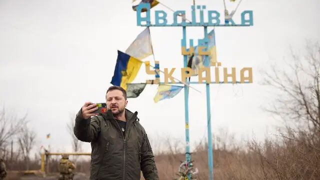 epa11048547 A handout picture made available by the Presidential Press Service shows Ukrainian President Volodymyr Zelensky recording his video address in front of the sign 'Avdiivka is Ukraine' during his trip to the Donetsk region, Ukraine, 29 December 2023. President of Ukraine Volodymyr Zelenskyy visited the advanced checkpoint of the 110th Separate Mechanized Brigade named after General-Corporal Marko Bezruchko, staying in Avdiivka. EPA/PRESIDENTIAL PRESS SERVICE HANDOUT HANDOUT HANDOUT EDITORIAL USE ONLY/NO SALES HANDOUT EDITORIAL USE ONLY/NO SALES