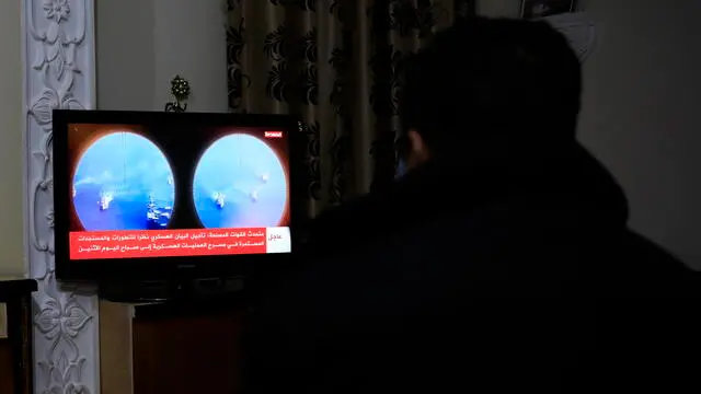 epa11165363 A person watches the news on a Houthis-run TV after a UK-registered ship came under attack in the Red Sea, in Sana'a, Yemen, 19 February 2024. A UK-registered cargo ship came under attack on 18 February in the Red Sea off the coast of Yemen, according to the UK's Maritime Trade Operations (UKMTO). The attack came just a day after the US forces launched five strikes on Houthi targets, including an unmanned underwater vessel, in Yemen. The US designation of Yemen's Houthis as a 'Specially Designated Global Terrorist group' came into effect on 16 February, due to their increased attacks on shipping lanes in the Red Sea and the Gulf of Aden since November 2023. The US Department of Defense announced in December 2023 a multinational operation to safeguard trade and protect ships in the Red Sea in response to the escalation of Houthi attacks.  EPA/YAHYA ARHAB