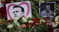 epa11163497 Portraits of deceased Alexei Navalny are positioned between flowers during a rally in reaction to the death of Russian opposition leader Alexei Navalny in front of the Russian embassy, in Berlin, Germany, 18 February 2024. Russian opposition leader and outspoken Kremlin critic Alexei Navalny has died aged 47 in a penal colony, the Federal Penitentiary Service of the Yamalo-Nenets Autonomous District announced on 16 February 2024. A prison service statement said that Navalny 'felt unwell' after a walk on 16 February, and it was investigating the causes of his death. In late 2023 Navalny was transferred to an Arctic penal colony considered one of the harshest prisons.  EPA/CLEMENS BILAN