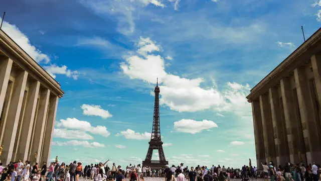 epa10797050 People stand near the Eiffel tower at Place Trocadero in Paris, France, 12 August 2023. According to Societe D'exploitation De La Tour Eiffel (SETE) 'lit.: Eiffel Tower Operating Company', three floors of Eiffel Tower were briefly evacuated after security threat announced.  EPA/MOHAMMED BADRA