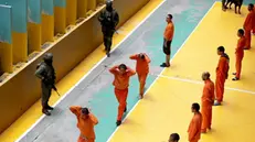 epa11173766 Inmates perform exercises during a press tour around Cotopaxi prison in Latacunga, Ecuador, 22 February 2024. More than a month and a half after the "internal armed conflict" against organized crime was declared in Ecuador, prisons remain under the control of the Armed Forces to wrest internal control of the prisons from criminal gangs.  EPA/Jose Jacome