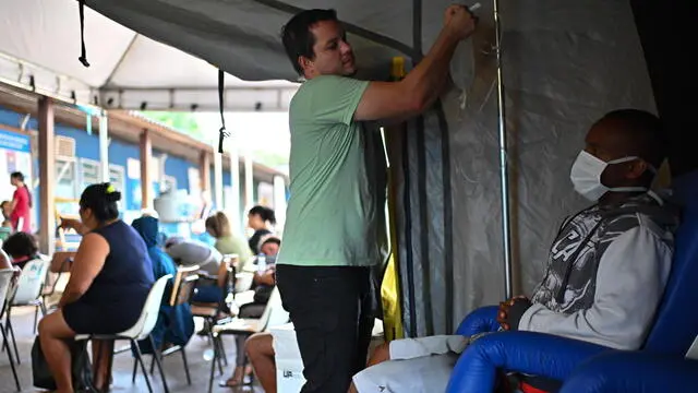 epa11172567 A man receives medical attention in a tent to treat suspected cases of dengue, in the administrative region of Sao Sebastiao, on the outskirts of Brasilia, Brazil, 20 February 2024 (issued 22 February 2024). In the midst of the worst peak in recent years, Brazil is fighting dengue door-to-door with fumigations and awareness campaigns among the population that seek to end the country's number one public enemy: the Aedes aegypti mosquito. So far this year, 715,000 cases and 135 deaths have been reported throughout Brazil, and another 481 deaths that could be related to the disease are being investigated, according to the latest figures from the Ministry of Health.  EPA/Andre Borges