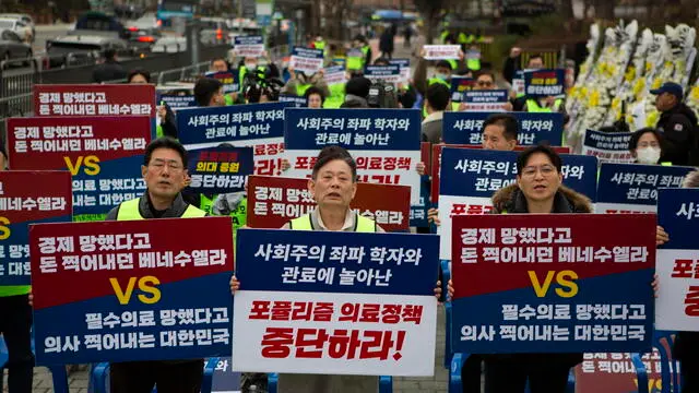 epa11186112 Doctors of Gyonggi-do medical association hold signs reading 'Stop Populism medical policy', during a protest against the government's medical policy, near the presidential office in Seoul, South Korea, 28 February 2024. South Korean hospitals earlier in February turned away patients and delayed surgeries, amid spiking tensions between doctors and the government over the latter's plan to increase the number of medical students. More than half of the country's 13,000 trainee doctors submitted their resignations on 20 February in protest of the plan, citing pay and overworking conditions. EPA/JEON HEON-KYUN