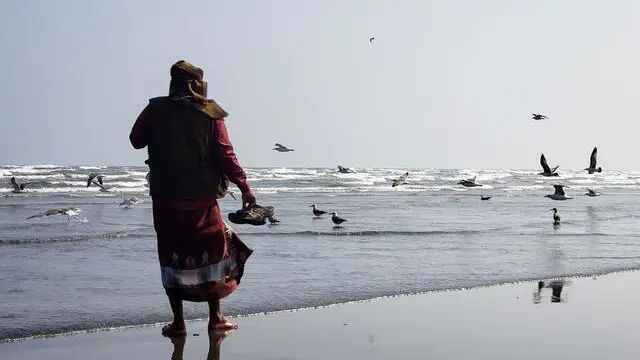 epa11043144 A person stands on the beach of the Arabian Sea near the Bab al-Mandab Strait, in the port city of Aden, Yemen, 22 December 2023 (issued 24 December 2023). The US Central Command reported that Yemen's Houthis on 23 December 2023 have launched anti-ship ballistic missiles at two commercial ships, the Gabon-owned, Indian-flagged crude oil tanker MV Saibaba and Norwegian-flagged MV Blaamanen, in the Southern Red Sea. The US Department of Defense had announced on 18 December a multinational operation to safeguard trade and to protect ships in the Red Sea amid the recent escalation in Houthi attacks originating from Yemen. These attacks in recent weeks had prompted major shipping companies to reroute their operations and raised concerns of prolonged disruptions to global trade. Houthis vowed to attack Israeli-bound ships and prevent them from navigating in the Red Sea and the Bab al-Mandab Strait in retaliation for Israel's airstrikes on the Gaza Strip, according to Houthi military spokesman Yahya Sarea. EPA/YAHYA ARHAB