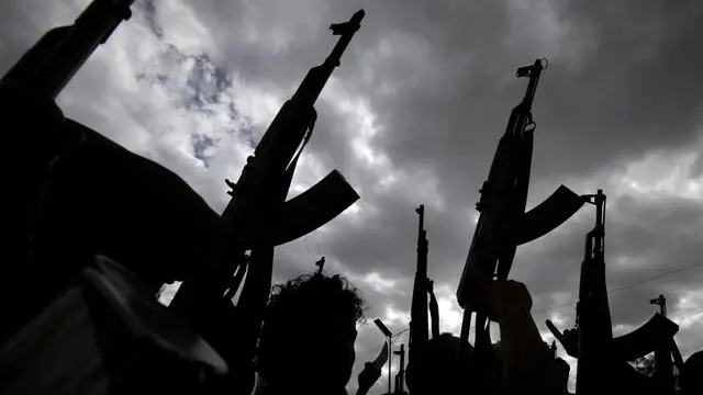 epa11191763 Armed Houthi supporters are silhouetted during a protest against the US and Israel and in support of Palestinians, in Sana'a, Yemen, 01 March 2024. Thousands of Houthi supporters demonstrated in Sana'a to protest against the US and Israel and in support of Palestinian people in the Gaza Strip. Yemen's Houthis have fired some 384 missiles and drones at shipping vessels since mid-November 2023, when they started attacking maritime targets in the Red Sea and Gulf of Aden, according to Houthi leader Abdul-Malik al-Houthi. The US-led coalition continues to strike Houthi targets in Yemen as it seeks to degrade the Houthis' abilities to attack commercial shipping vessels in the Red Sea and the Gulf of Aden amid high tensions in the Middle East. In light of increased maritime security threats, the US has designated the Houthis as a 'Specially Designated Global Terrorist Group'. EPA/YAHYA ARHAB