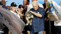 epa10673795 Former Panamanian President Ricardo Martinelli (C) carries his dog Bruno and celebrates with his wife Marta Linares (C-L), among others, after winning the Realizando Metas (RM) party primaries for the 2024 presidential elections, in Panama City, Panama, 04 June 2023. Martinelli, who governed Panama between 2009 and 2014, made his presidential candidacy official for the May 2024 elections, while he awaits a sentence on money laundering charges for the irregular purchase of a media publisher and the start of the trial for the Odebrecht case. Martinelli, 71, was proclaimed the presidential candidate of his new party Realizing Goals (RM), founded in 2021, after winning a primary in which he obtained more than 96% of the votes, according to data from the Electoral Tribunal (TE) of Panama. EPA/Bienvenido Velasco