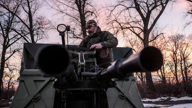 epa11049393 A Ukrainian serviceman of the 241st Brigade of Territorial Defense forces operates an anti-aircraft machine gun after an air raid alarm in the Kyiv region, Ukraine, 29 December 2023. At least 18 people have died and over 130 were injured after Russia launched a wave of airstrikes across Ukraine, Ukraine's Ministry of Internal Affairs said on 29 December. Strikes were reported in Kyiv, Lviv, Odesa, Dnipro, Kharkiv, Zaporizhzhia, and other Ukrainian cities. Russia launched 'more than 150 missiles and combat drones' at Ukrainian cities, Ukraine's Prosecutor General Andriy Kostin said in a statement, adding that extensive damage included residential buildings, educational institutions and hospitals. Russian troops entered Ukrainian territory on 24 February 2022, starting a conflict that has provoked destruction and a humanitarian crisis. EPA/Oleg Petrasyuk