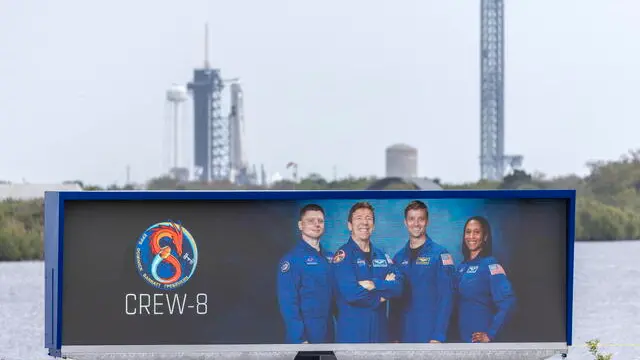 epa11194636 The NASA's SpaceX Dragon Endeavour spacecraft on a Falcon 9 rocket, that will carry the Crew-8 is the eighth crew rotation mission, is docked at the Kennedy Space Center Launch Complex 39A as part of its launch preparations, behind the NASA Press Site clock that shows a picture of the Crew-8 members in Florida, USA, 02 March 2024. The NASA Crew 8 mission members are (L-R) Roscosmos cosmonaut mission specialist Alexander Grebenkin, NASA astronaut Michael Barratt, pilot, NASA astronaut Matthew Dominick, commander, and NASA astronaut Jeanette Epps, mission specialist. According to NASA, SpaceX's Crew-8 mission is the ninth flight to the International Space Station (ISS) with astronauts, including the Demo-2 test flight, as part of NASA's Commercial Crew Program. EPA/CRISTOBAL HERRERA-ULASHKEVICH