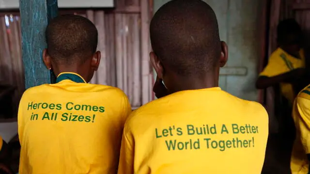 epa10434478 Students of Mawumadoka orphans and Less Privileged School wear school uniforms with inscriptions in a class in the school built with Bamboo materials in the Makoko riverine community in Lagos, Nigeria 27 January 2023. The founder of the school which began in August 2018, Joshua moved from his from his small space to his mother's parlour with 78 orphans to render humanitarian services and provide free education, free feeding, clothings, and edunation materials to children of the poor and underprivileged in the community. The school had run on charitable gifts from some non-governmental organisations, including churches and other religious organisations. EPA/Akintunde Akinleye