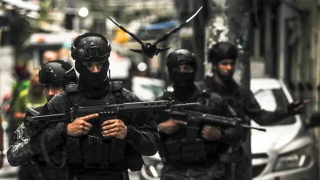 epa10909670 Police participate in an operation against criminal gangs in a favela in Rio de Janeiro, Brazil, 09 October 2023. Nearly 1,000 police officers were deployed in three of the most violent favelas in Rio de Janeiro in a mega-operation with which authorities seek to catch leaders of the Red Command, one of the most dangerous criminal organizations in Brazil, official sources reported. The actions took place in Complexo da Mare, Vila Cruzeiro and Cidade de Deus, where the agents seek to fulfill 100 arrest warrants, according to the secretary of the Civil Police of the state of Rio de Janeiro, Jose Renato Torres, in a press conference. EPA/Antonio Lacerda BEST QUALITY AVAILABLE